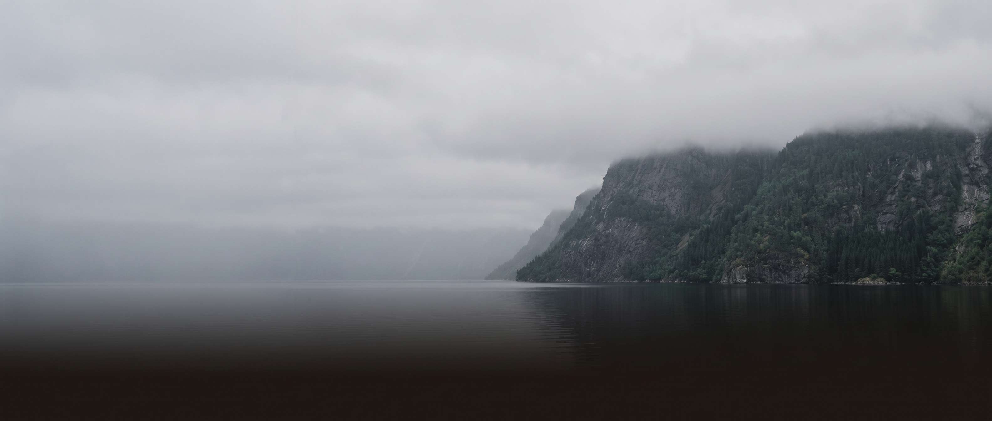 A fjord under low cloud.